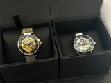two watches that are in a box on the table