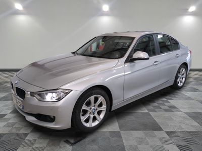 a picture of a silver bmw car in a showroom
