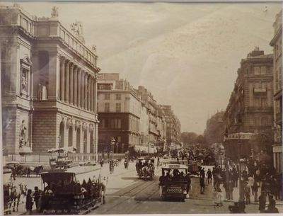 an old picture of a city street with people and cars on it