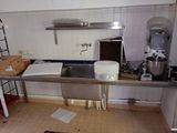 an image of a kitchen with a lot of clutter
