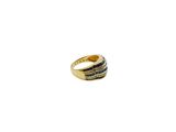 an image of a gold ring with black and white stripes