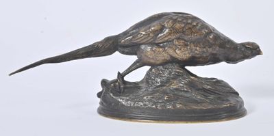 a bronze statue of a pheasant on top of a rock