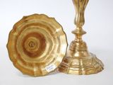 two gold vases sitting next to each other on a table