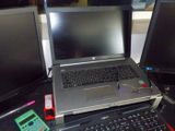 a laptop computer sitting on top of a desk next to two monitors