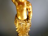 a gold statue of a man with a hat on his head
