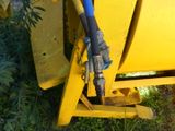 a blue hose attached to the side of a yellow truck