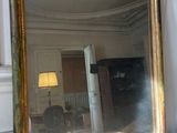 a large mirror sitting on a table in a room