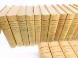 several old books are stacked on top of each other on a table