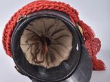 a red hat with a red scarf and a black hat