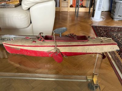 a wooden boat on a glass table in a living room