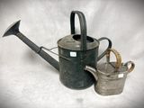 a small watering can and a small watering can on a white background