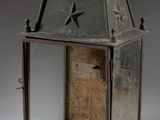 an old metal lantern with a star on the top of it