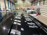many cars that are parked inside of a building