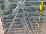 a plastic bag that has a yellow handle on top of it