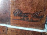 a close up of a piece of wood with a logo on it