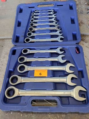 a set of wrenches in a blue case sitting on the ground