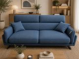 a blue couch sitting in a living room next to a coffee table