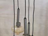 a chandelier with five lights hanging from it ' s ceiling