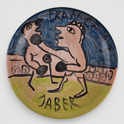 a plate with a drawing of a man and a dog on it