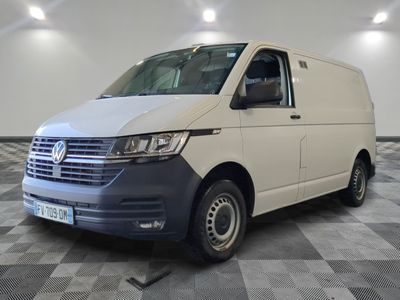 the white van is parked on a checkered floor in the garage