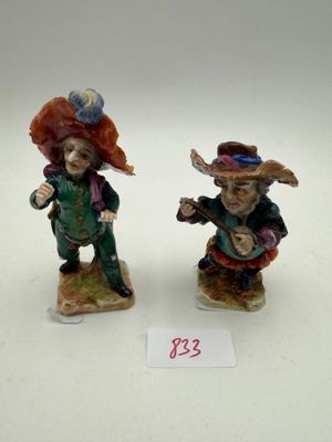 two figurines of a man and a woman with a guitar