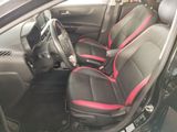 the interior of a car with black and red seats and a steering wheel