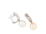 a pair of pearl and diamond earrings on a white background