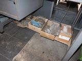 a box of assorted items sitting on the floor in a room