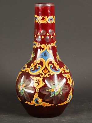 a red vase with gold and blue designs on it