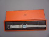 an orange box with a watch inside of it sitting on a table