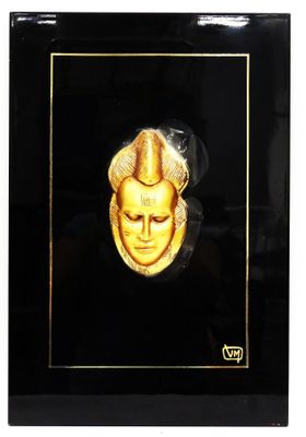 a close up of a picture of a person wearing a gold mask