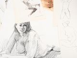 sketches of a woman sitting on a bed next to a pile of papers