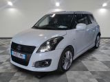 the white suzuki swift is parked on a checkered floor