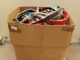 a cardboard box full of assorted items sitting on the floor