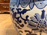 a large blue and white vase sitting on a wooden table