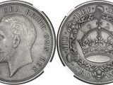 a close up of a silver coin with a crown on it