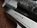 a close up of a gun on a brown carpet