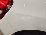 a close up of a white car with a red tail light