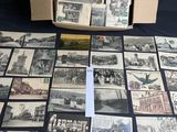 an old photo of a bunch of old postcards in a box