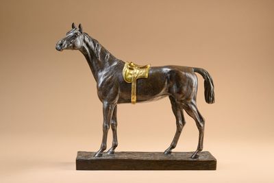 an image of a statue of a horse on a wooden base