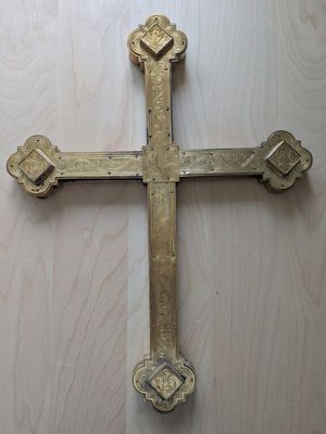 a cross that is on a wooden table