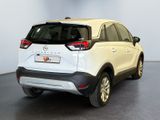 the rear end of a white car parked in a room