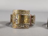 two silver and gold cuff bracelets with a buckle on each of them