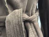 a close up of a person wearing a robe with a tie