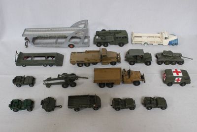 a lot of toy military vehicles and trucks on a white surface