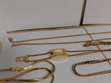 a lot of gold necklaces and bracelets on the table