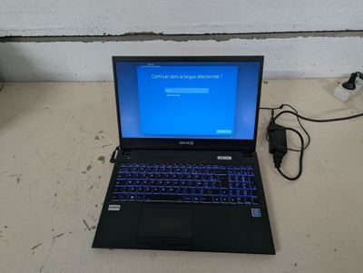 a laptop that is sitting on a table with a charger