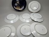 six plates and a bowl sitting on a table