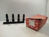 a red box with four black candles in it on a table