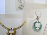 several different types of jewelry displayed on display in a glass case